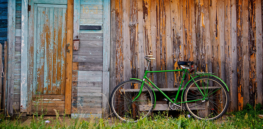Old wooden wall and green bicycle Cycle